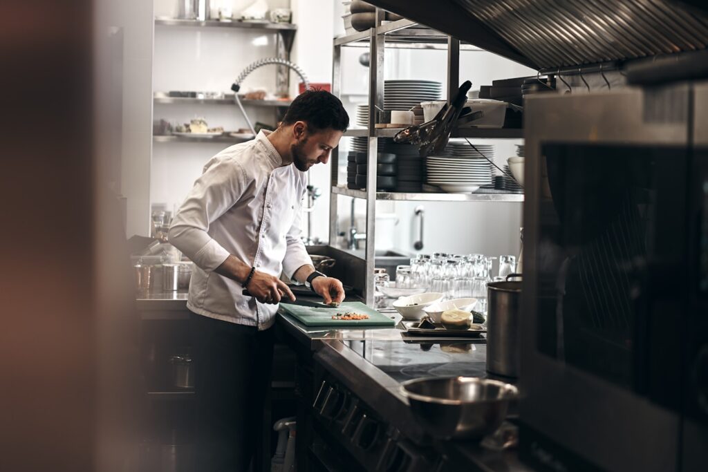 A chef dressed in a white coat working in a kitchen. 
@novokayn on Instagram